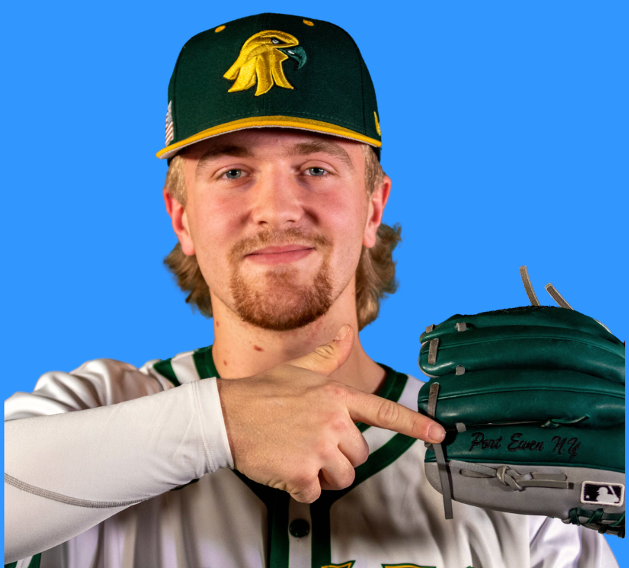 Coach Deising in his jersey and hat, pointing at a glove